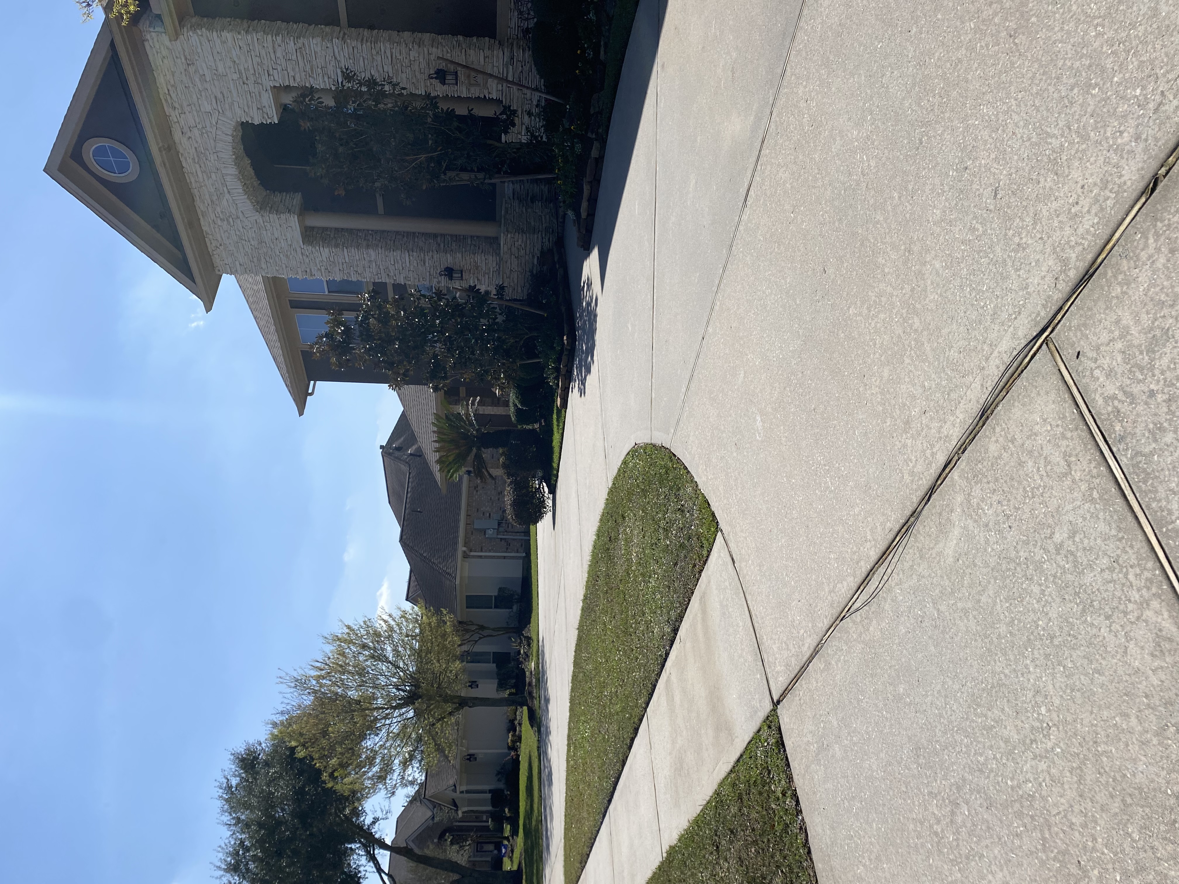 Clean stucco home driveway after