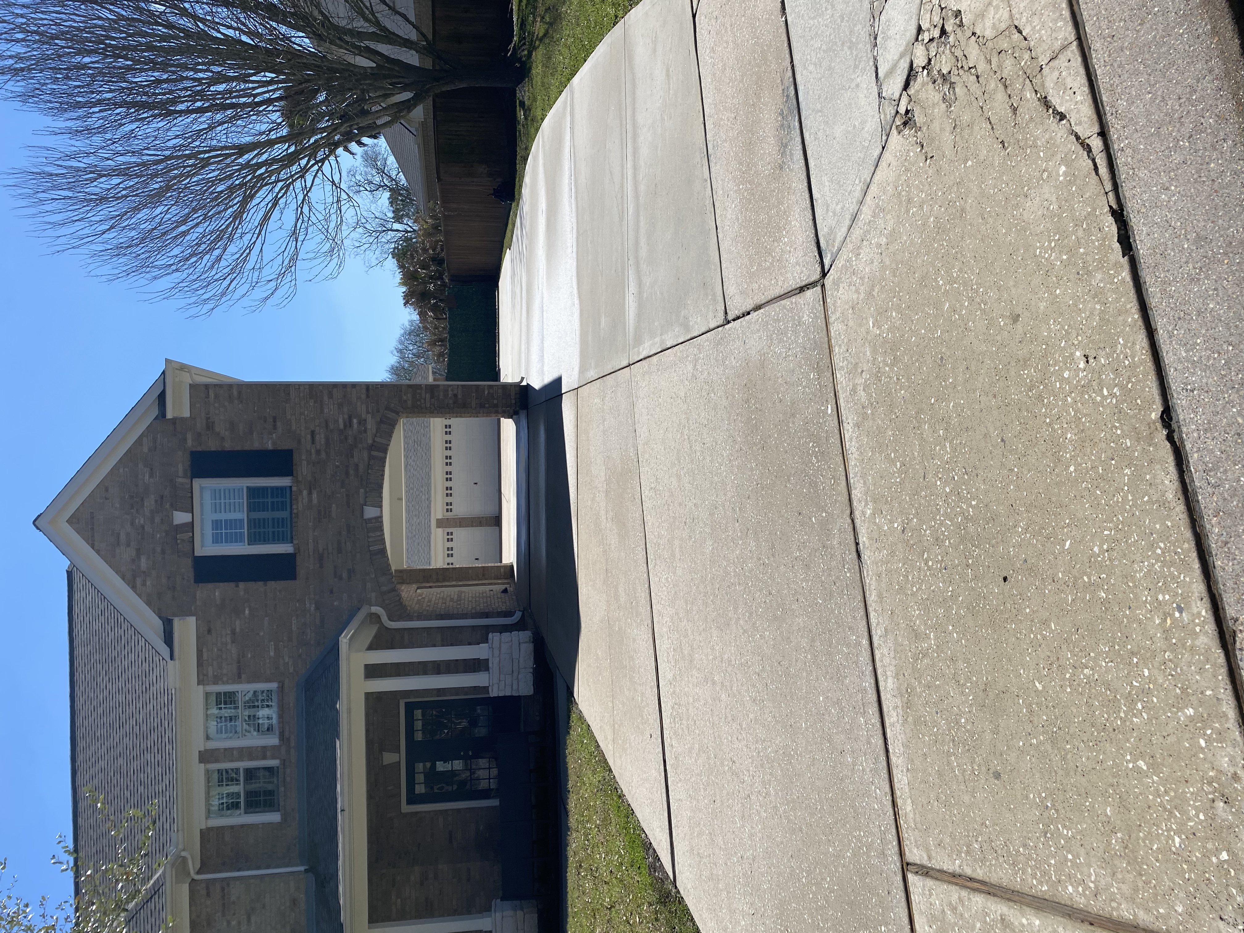 Clean brick home driveway after